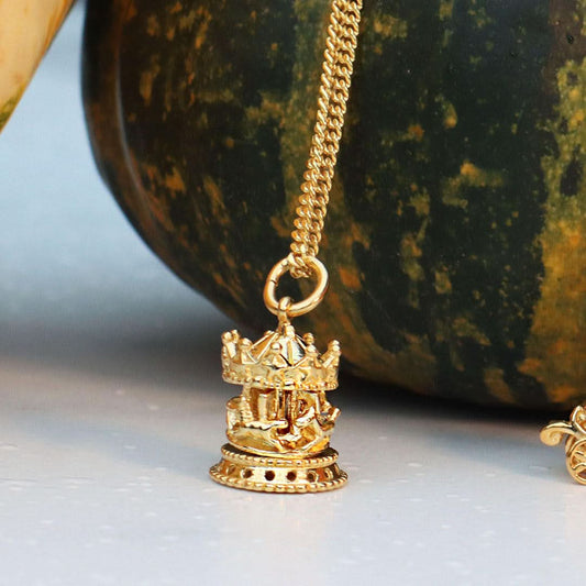 gold charm necklace with carousel