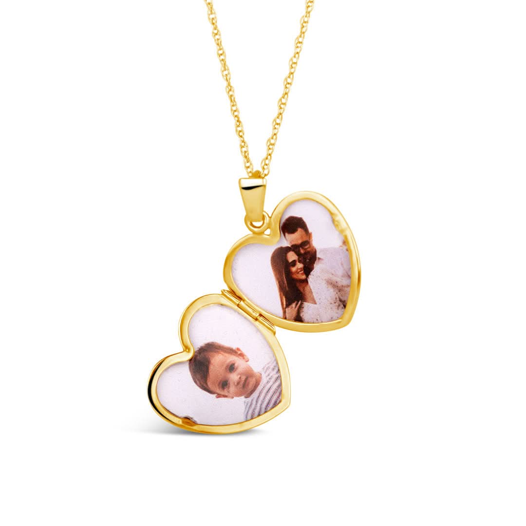opened diamond heart locket in gold with family photos inside