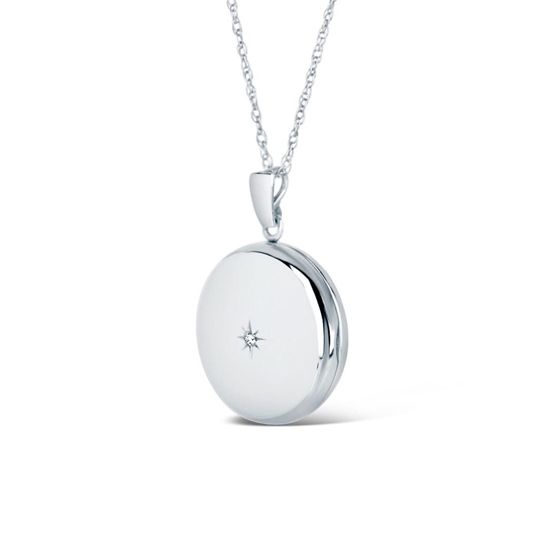 solid white gold round diamond locket on a white background