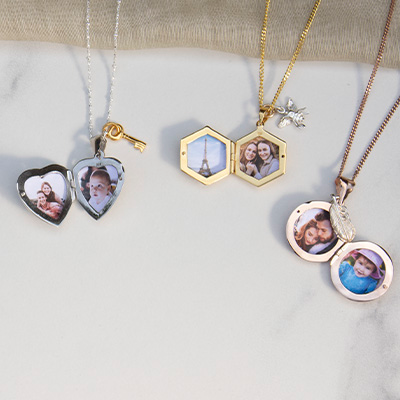 Picture lockets lying open with photographs of people, pets & places inside