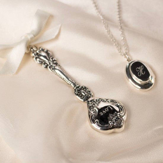 Sterling silver new baby rattle and sterling silver mother and baby locket by Lily Blanche 