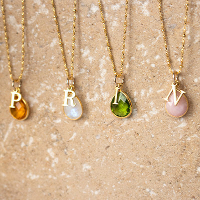 Four personalised birthstone charm necklaces from Lily Blanche 