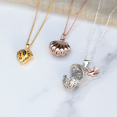 silver and gold necklaces lying flat 