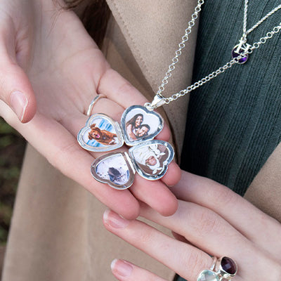 silver heart locket being held by a model