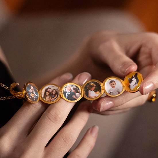 image of a female model's hand holding a gold vintage style locket with 6 photos inside