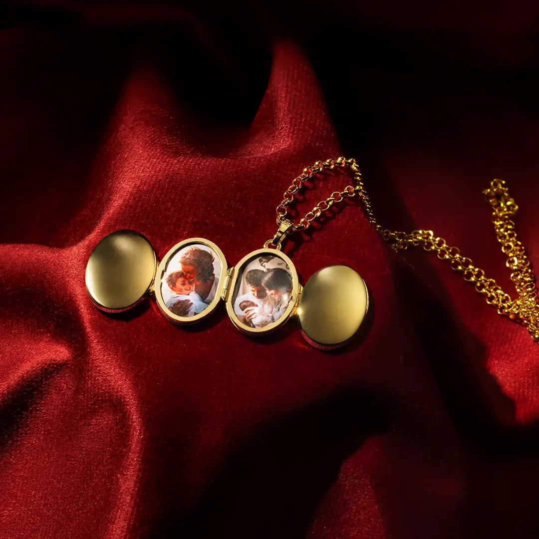 Open gold oval locket necklace displaying multiple family photos inside, styled on red velvet with dramatic lighting.