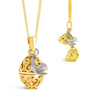 Gold filigree bird locket necklace with silver bird charm shown closed and partially open on a fine chain