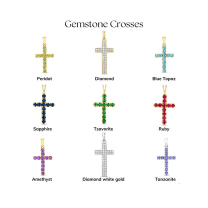 Collection of gemstone cross pendants showing peridot, diamond, blue topaz, sapphire, tsavorite, ruby, amethyst, diamond in white gold, and tanzanite options arranged on a white background with labels