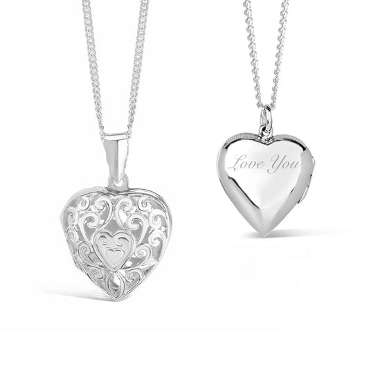 Front and back views of a sterling silver filigree heart locket necklace. The front features an intricate openwork scroll design with a small heart at the centre, while the back is polished and engraved with the words "Love You". The locket hangs from a sterling silver chain against a white background.