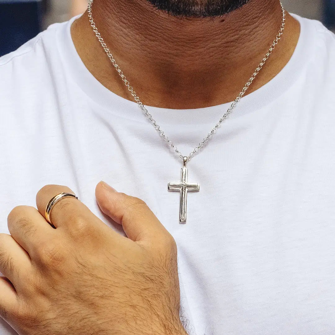 Sterling silver cross pendant necklace on chain, men’s necklace worn by model with white t-shirt. By Lily Blanche.