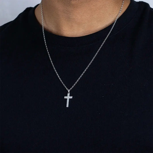 Man wearing white gold diamond cross necklace with pavé diamonds on fine chain, minimalist styling