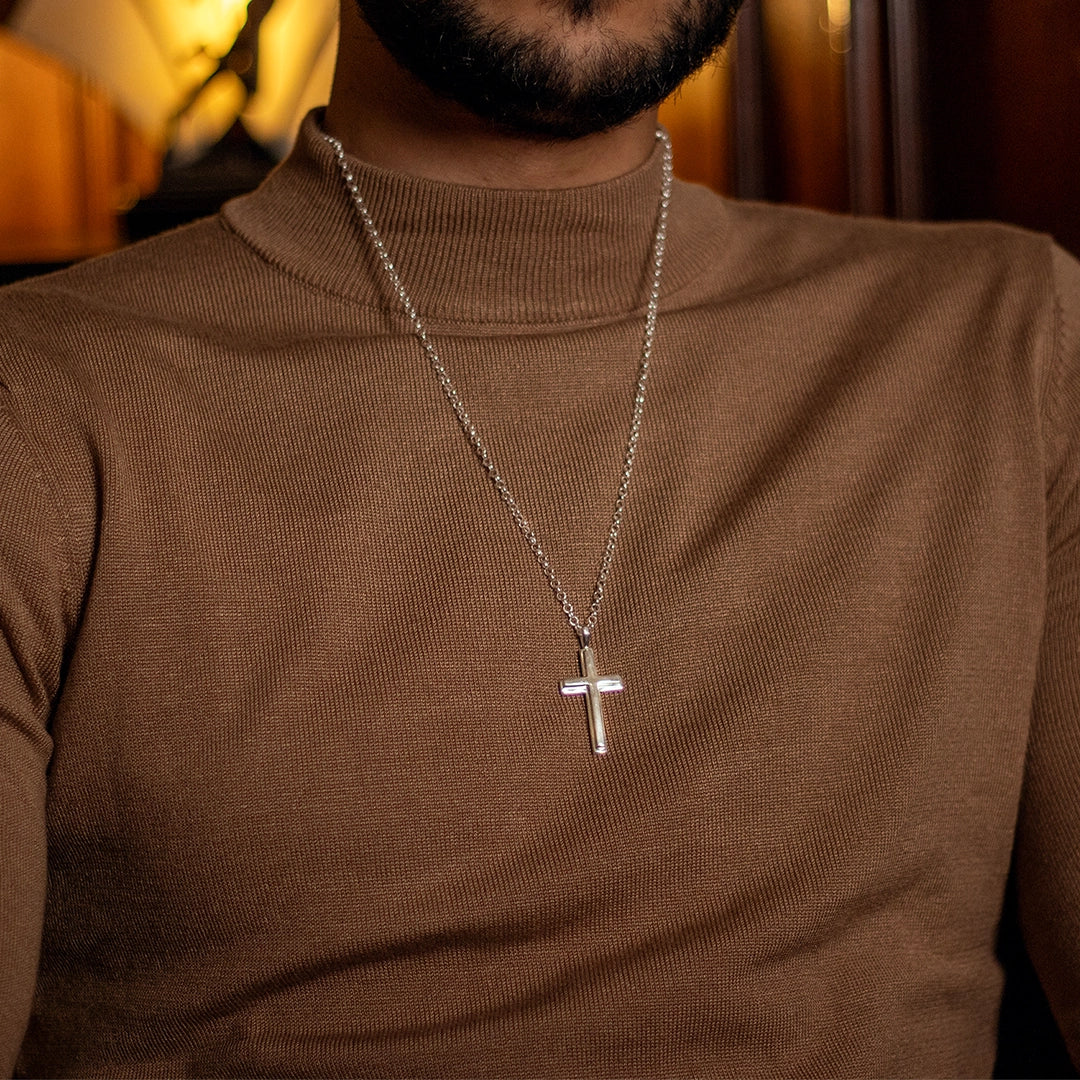 Sterling silver cross pendant necklace on chain, men’s jewellery worn by model in brown sweater. By Lily Blanche.