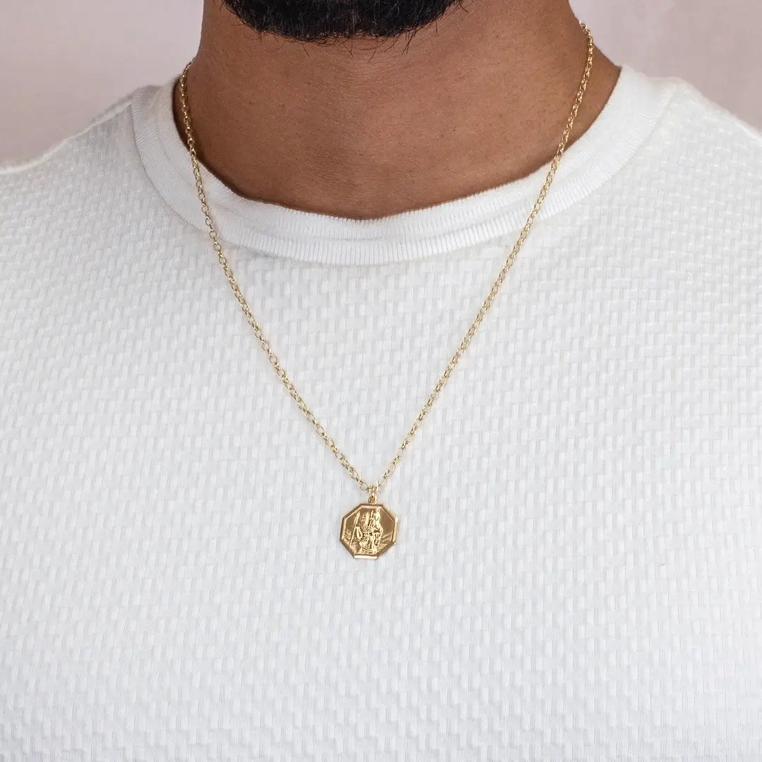 Men’s gold St Christopher hexagon pendant necklace worn on fine chain over white shirt