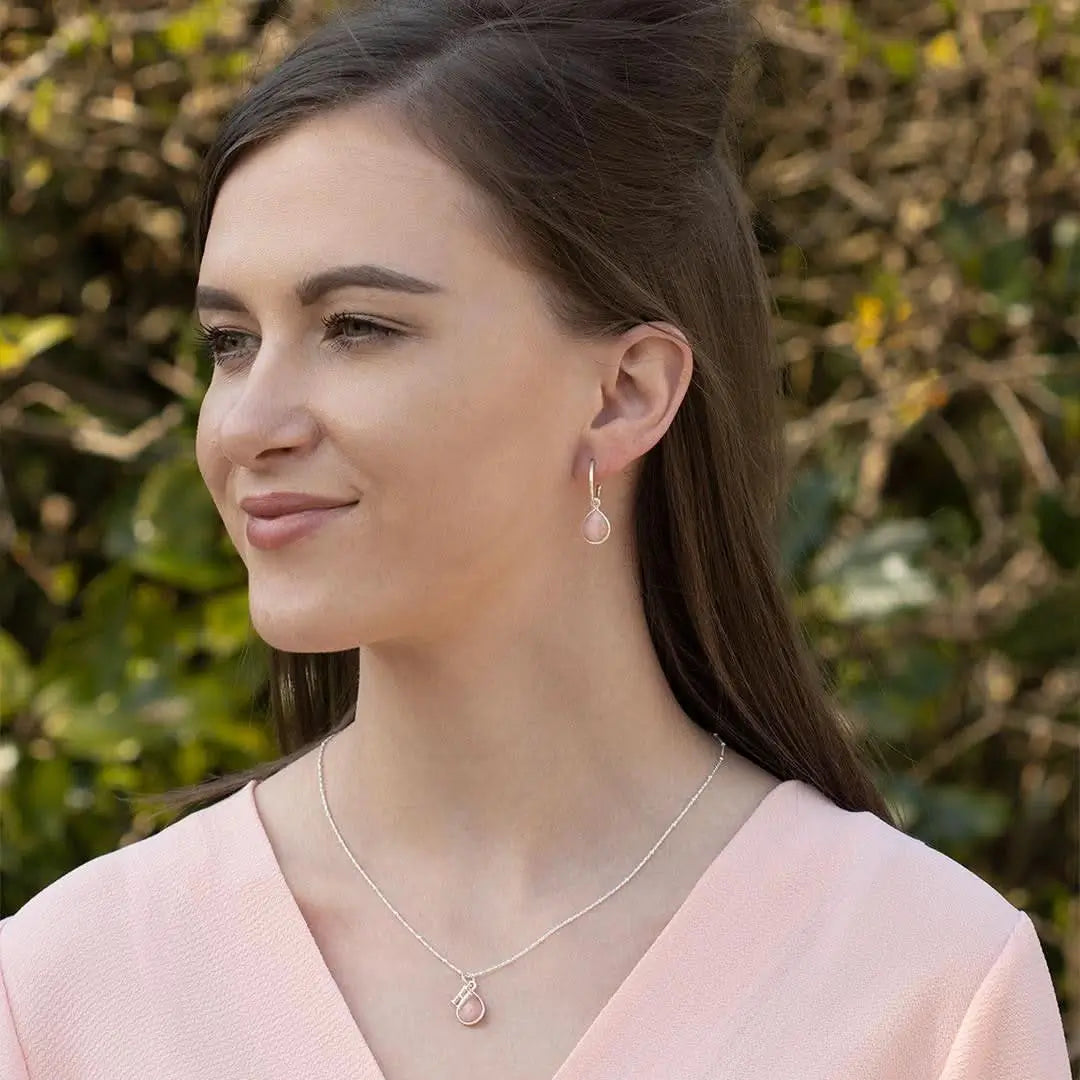 Pink opal drop necklace and matching earrings in sterling silver, elegant everyday jewellery worn by model