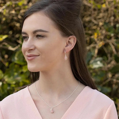 Pink opal drop necklace and matching earrings in sterling silver, elegant everyday jewellery worn by model