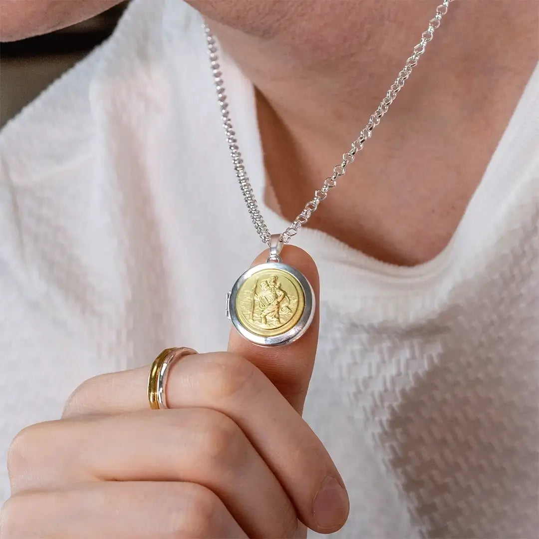 Close-up of men’s St Christopher locket necklace in silver and gold, classic protection jewellery