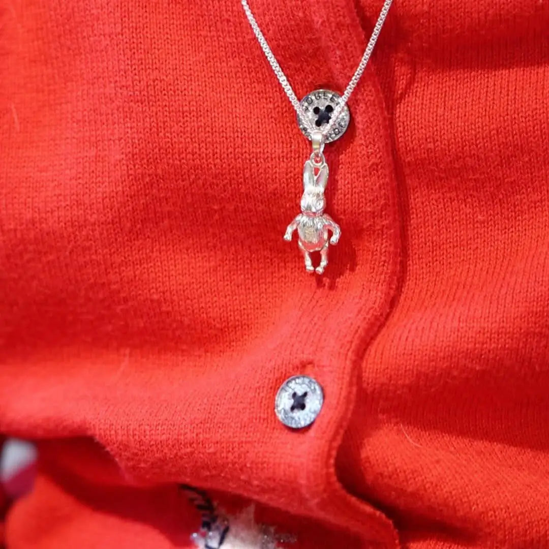 Sterling silver bunny pendant necklace worn on red knit cardigan, cute children’s jewellery gift