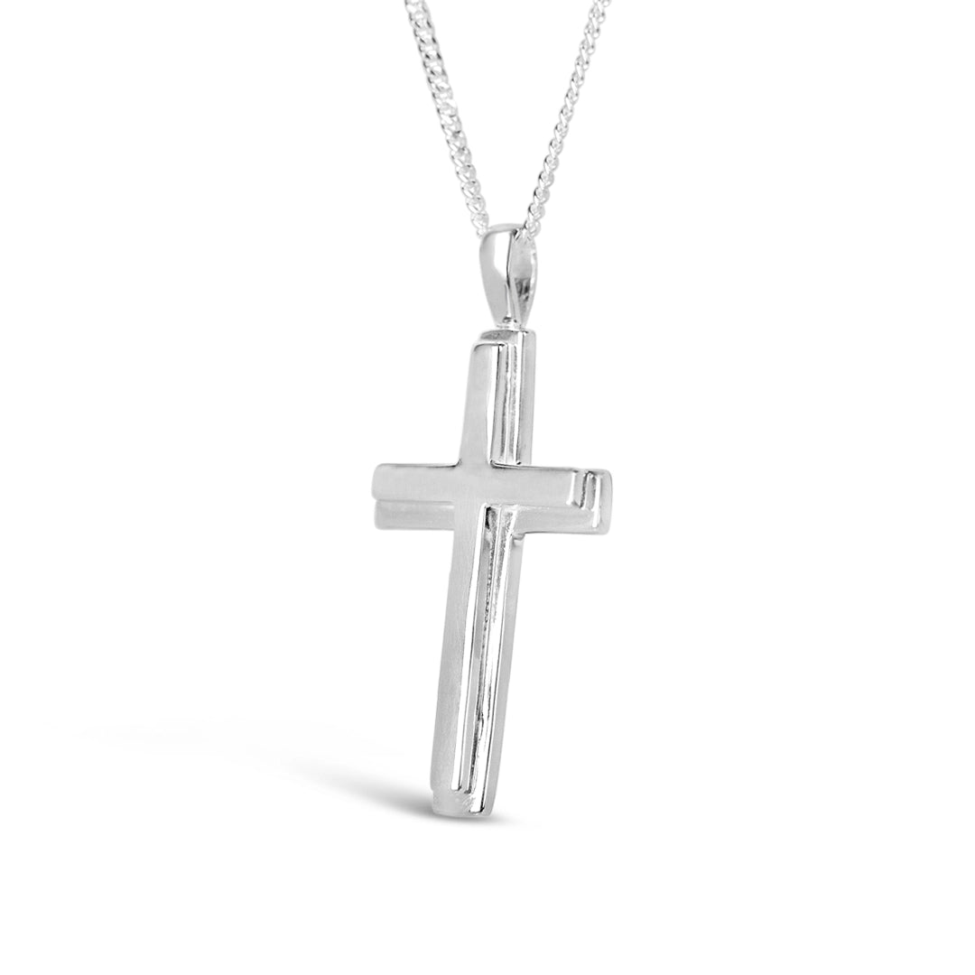 Sterling silver cross pendant necklace on chain, side view showing polished finish on white background. By Lily Blanche.