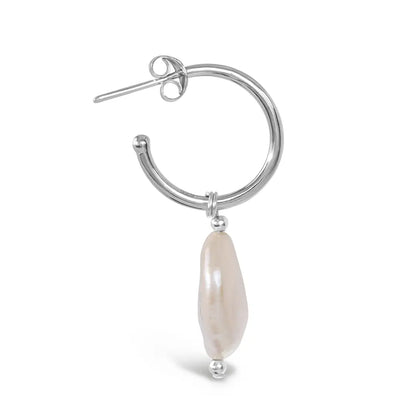 Close-up side view of silver hoop earring with elongated coin pearl drop detail