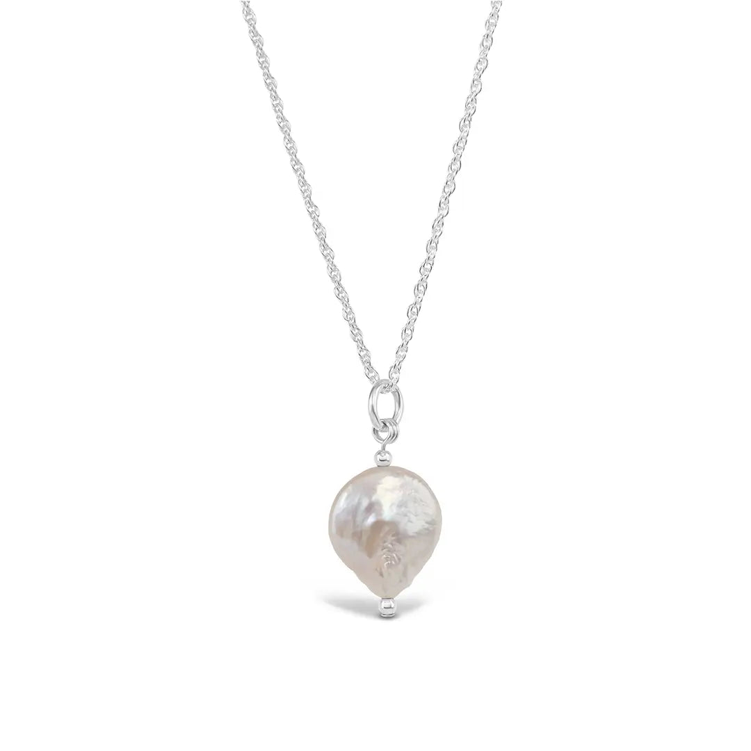 Sterling silver necklace with coin pearl pendant, minimalist design on white background showing freshwater pearl detail