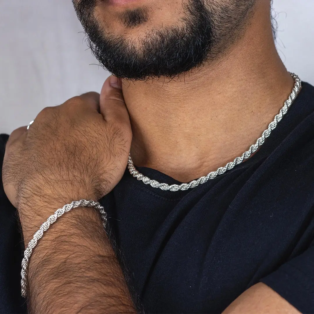 close up of a man in a black T-shirt wearing a heavyweight sterling silver rope chain necklace and bracelet 