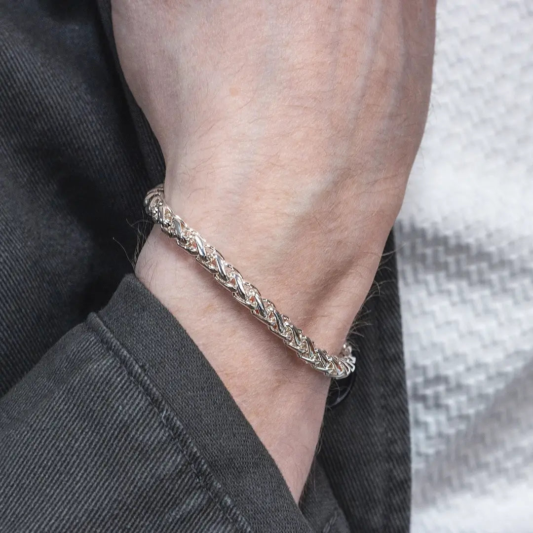 Sterling silver spiga chain bracelet on wrist, detailed woven chain design
