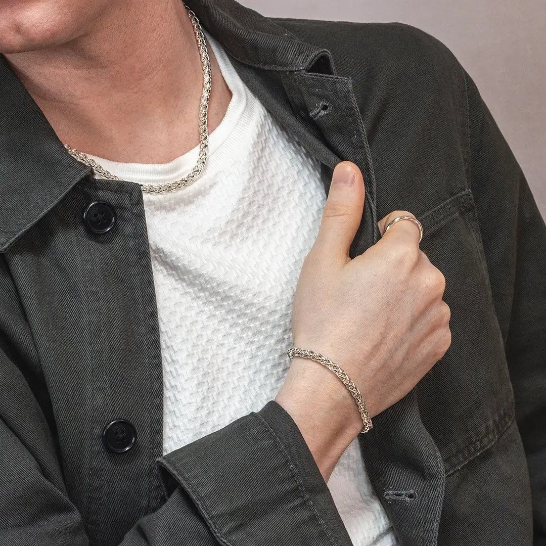 Sterling silver spiga chain bracelet worn by male model with matching chain necklace