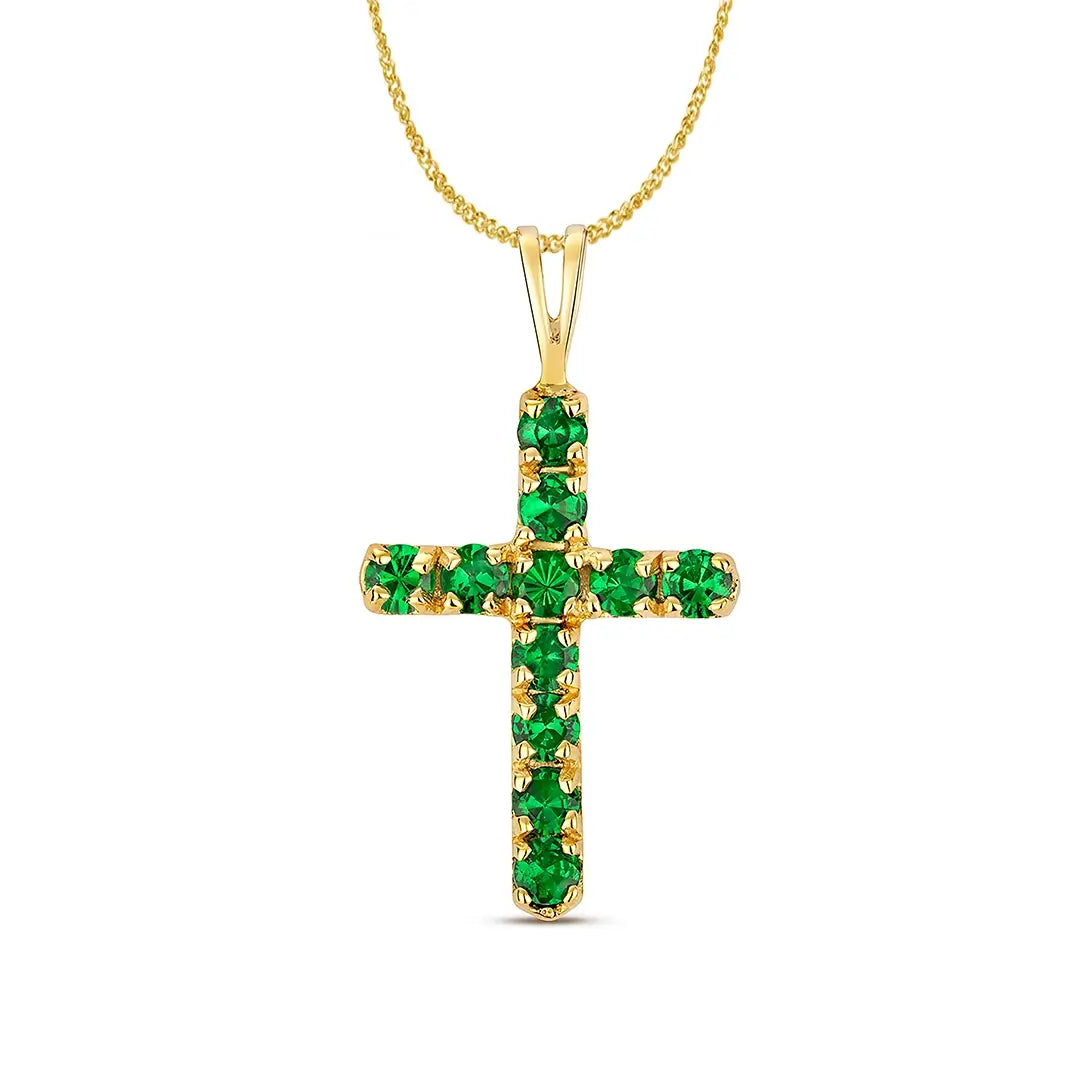 Close-up of a gold cross pendant set with round green tsavorite gemstones on a white background