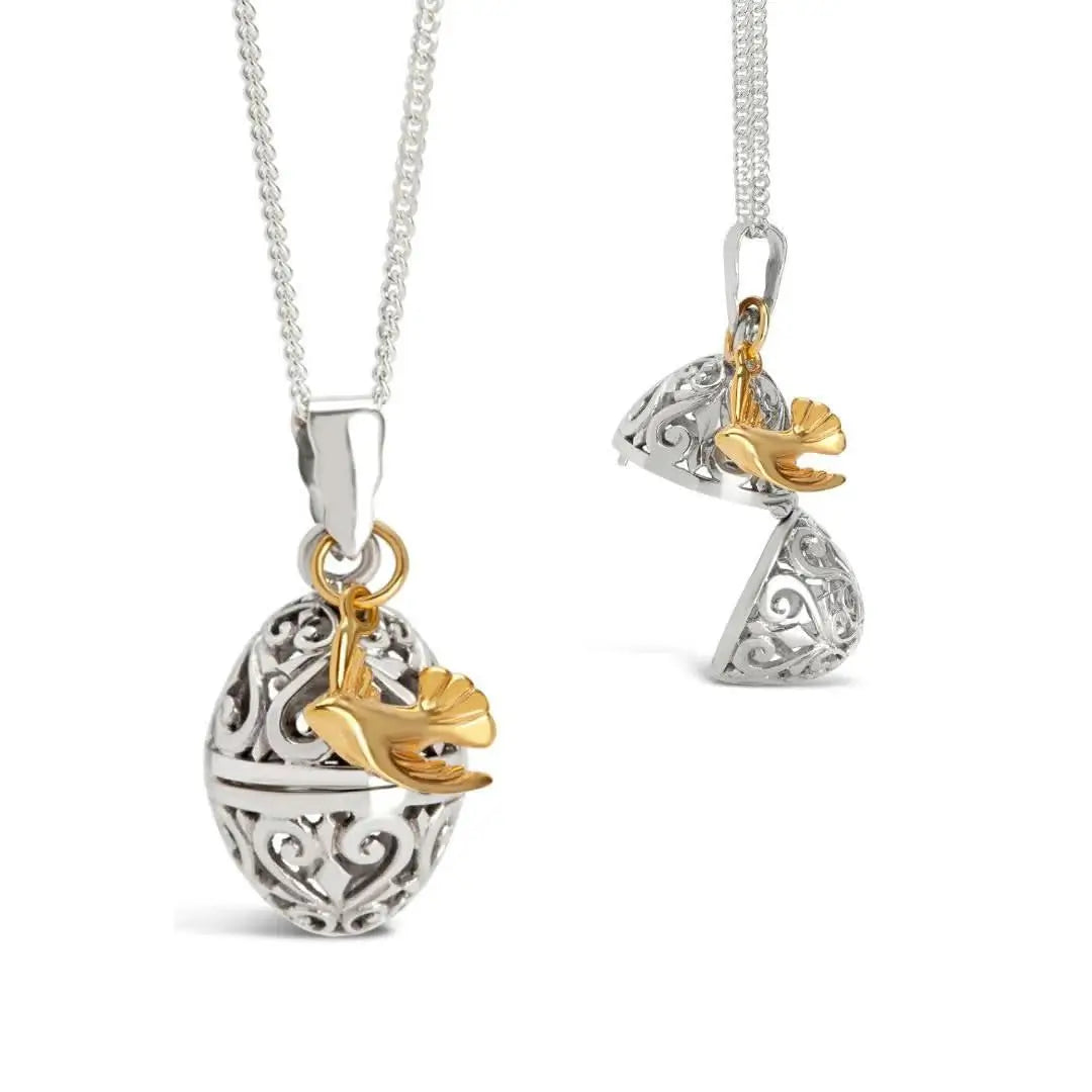 Sterling silver filigree locket with gold dove charm worn by model, elegant sentimental jewellery piece