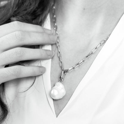 white baroque pearl on silver paperclip chain worn by model