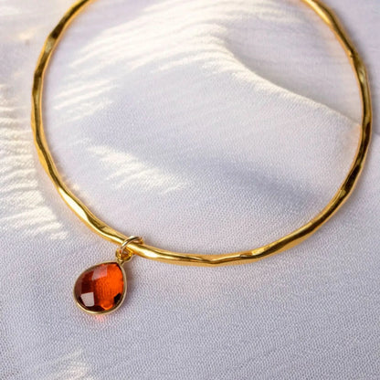 Close up of Gold Carnelian charm bangle