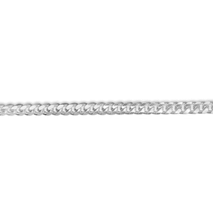 Flat sterling silver Cuban link chain laid out horizontally on a white background.