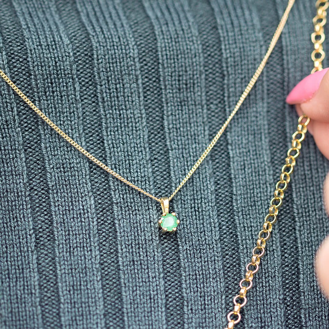 emerald solataire necklace in 9 carat gold by Lily Blanche on a model