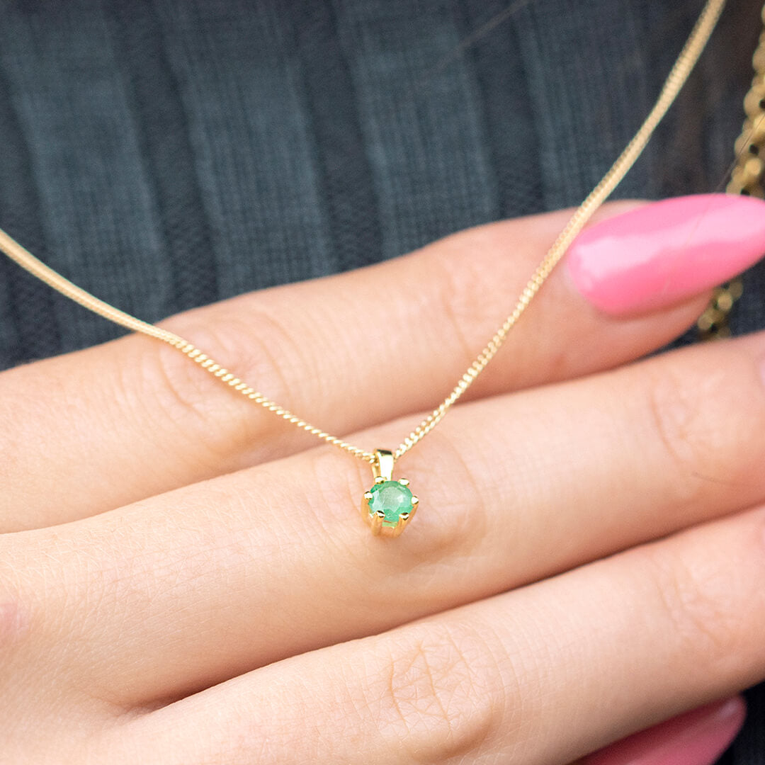 emerald solataire necklace in 9 carat gold by Lily Blanche on hand