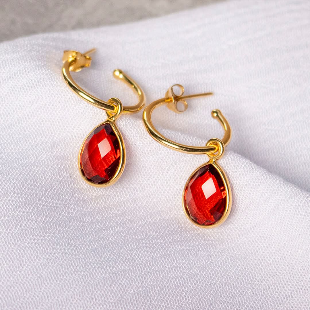 Gold hoop earrings with teardrop garnet gemstone drops