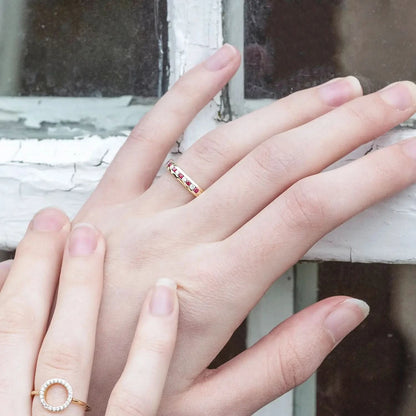 model wearing ruby and diamond gold band ring