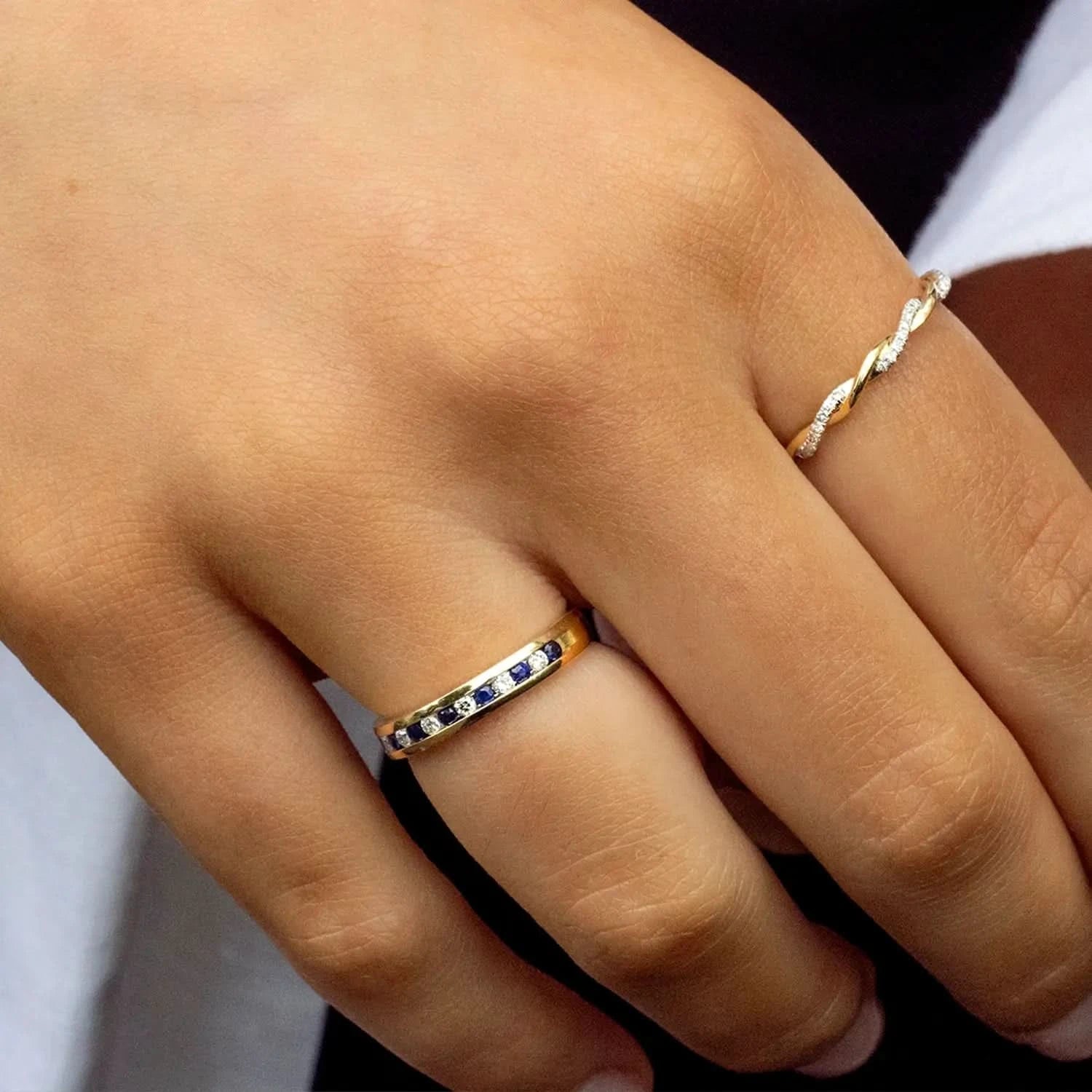 model wearing sapphire and diamond solid gold band ring 