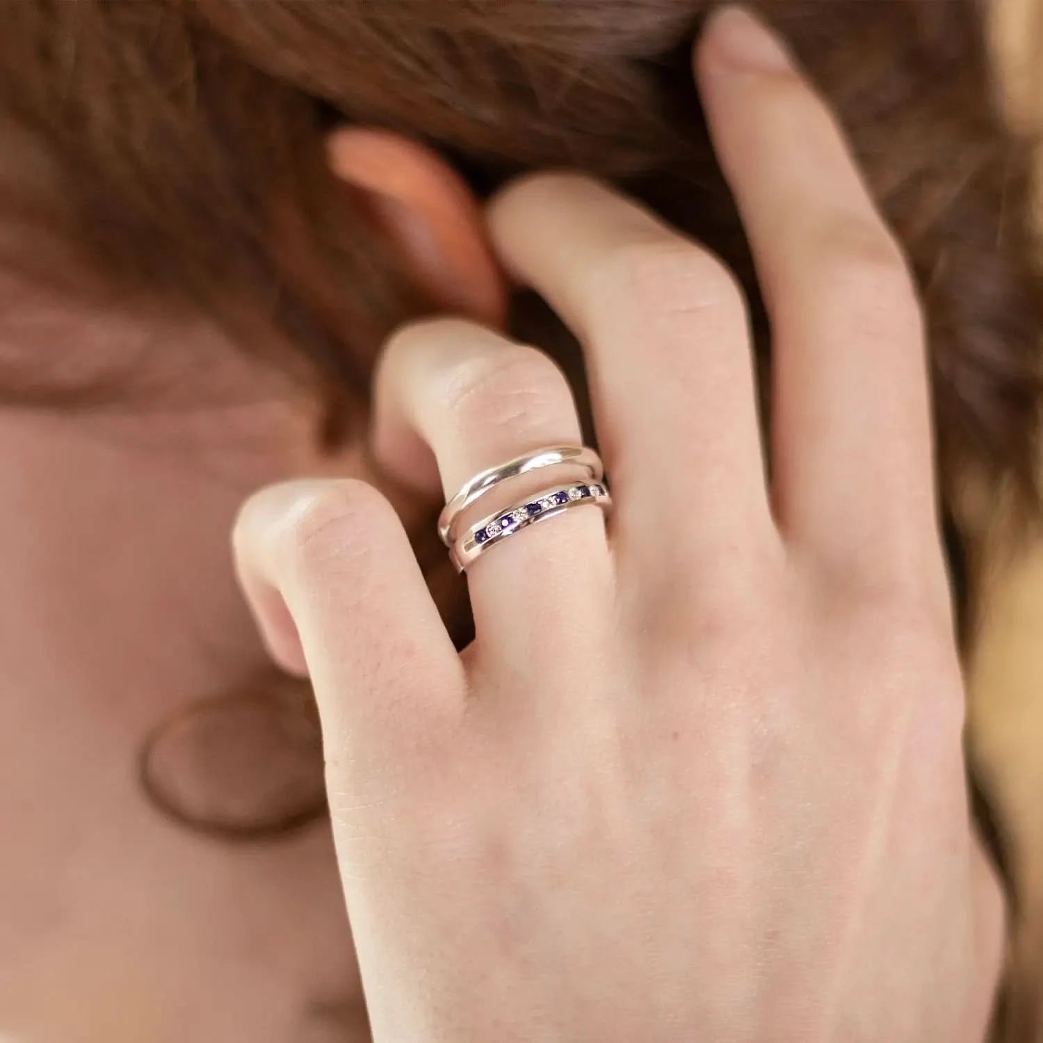 model wearing sapphire and diamond solid white gold band ring 