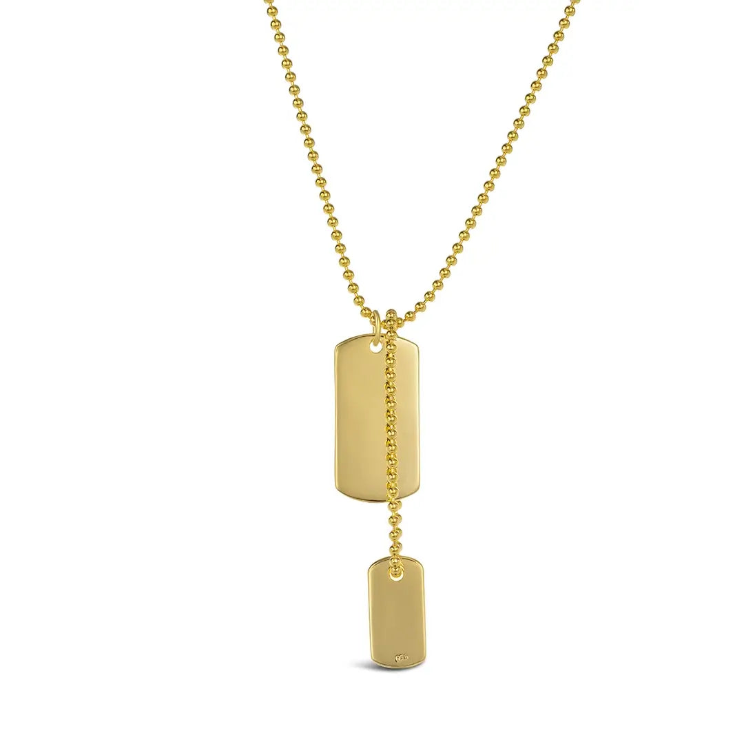 Gold dual dog tag necklace with two polished rectangular pendants on a popcorn chain.
