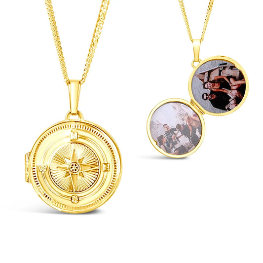 Front and inside views of gold round compass locket necklace on a gold curb chain  on a white background