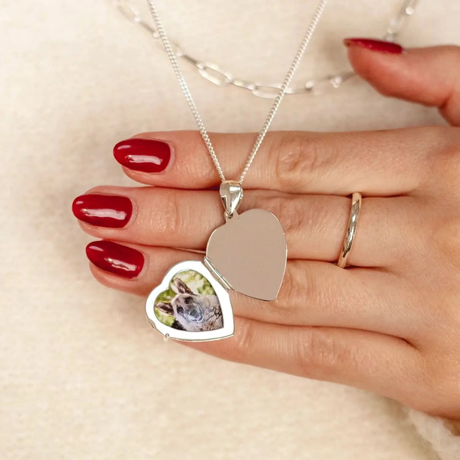 woman wearing Silver heart Necklace for ashes, memorial necklace, locket with one photo and ashes storage, silver curb chain, engraving 
