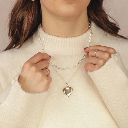 woman wearing Silver heart Necklace for ashes, memorial necklace, locket with one photo and ashes storage, silver curb chain, engraving, silver paperclip chain