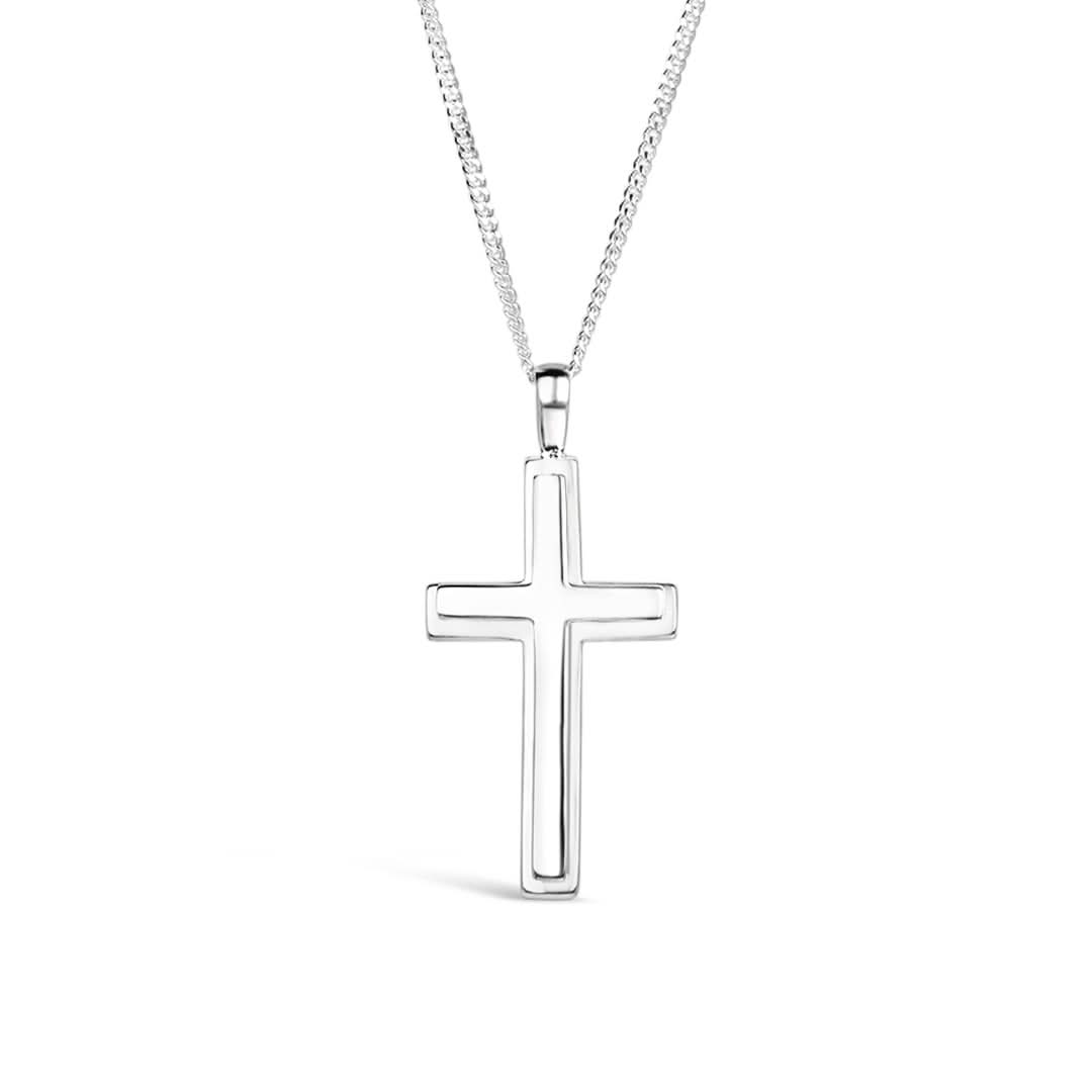 A heavyweight silver cross necklace for men hanging on a curb chain against a white background