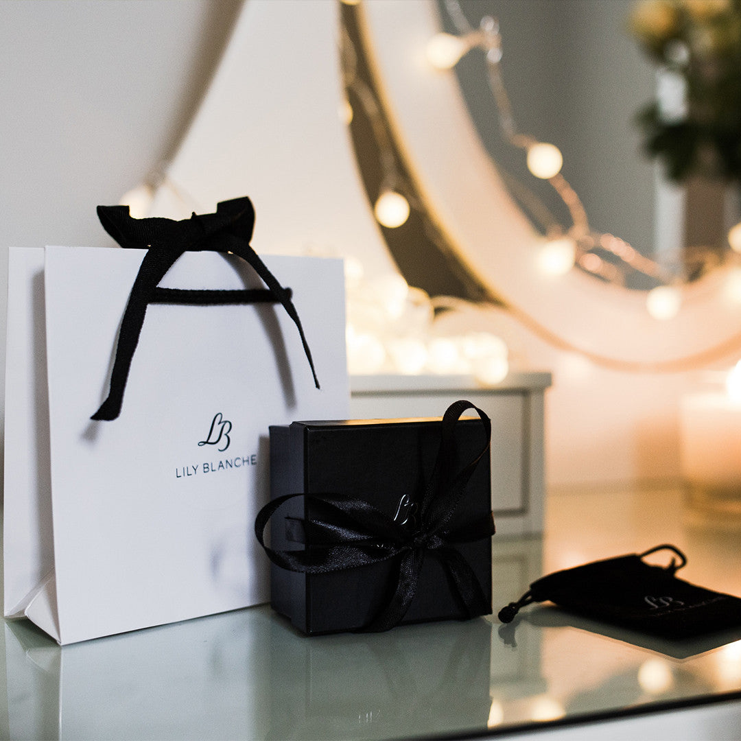Lily Blanche white ribbon tied gift bag with black ribbon tied gift box