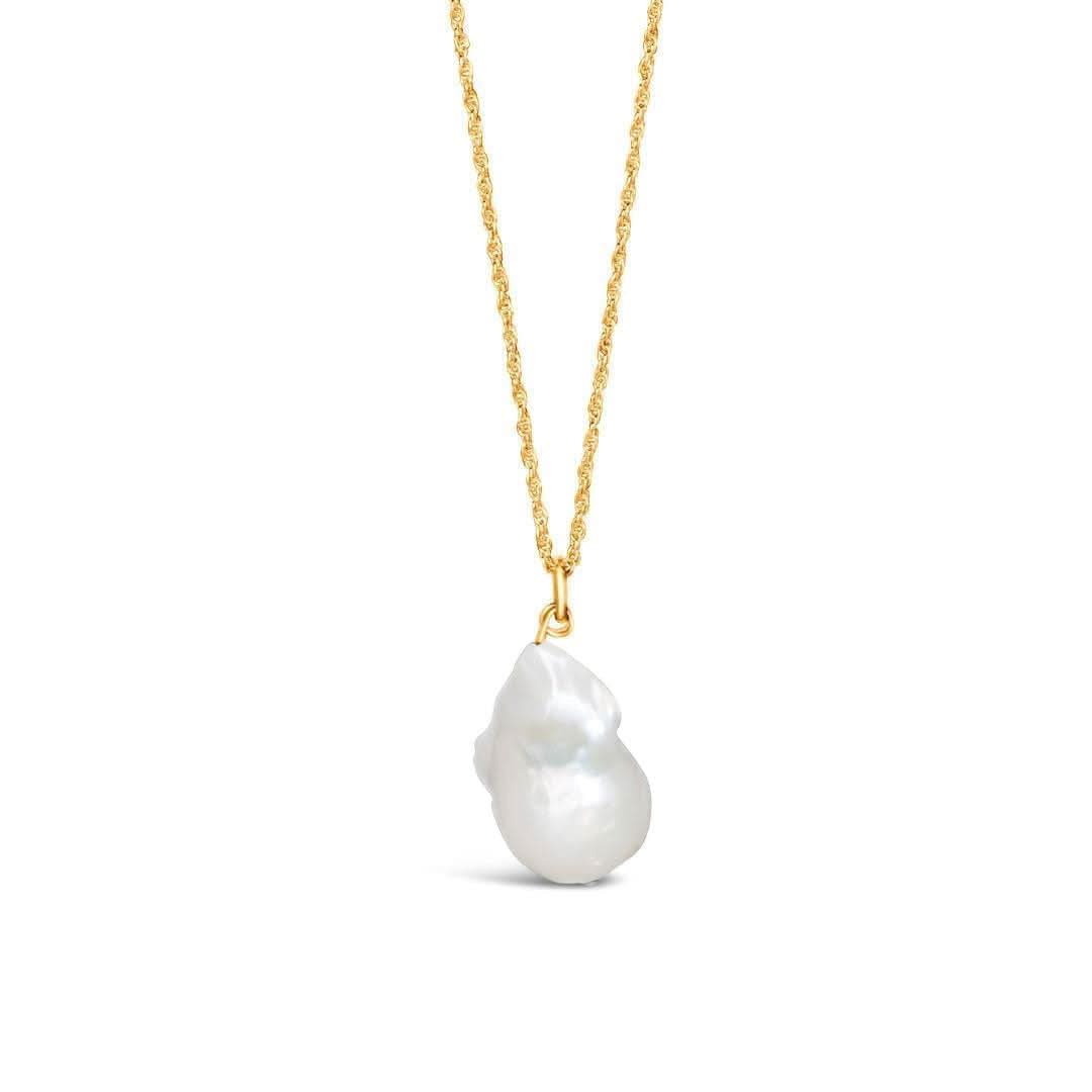 A ivory baroque pearl pendant attached to a gold vermeil chain, displayed on a plain background.