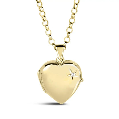 Closed gold heart locket necklace with a small diamond accent in a starburst design on the front, hanging from a gold chain.