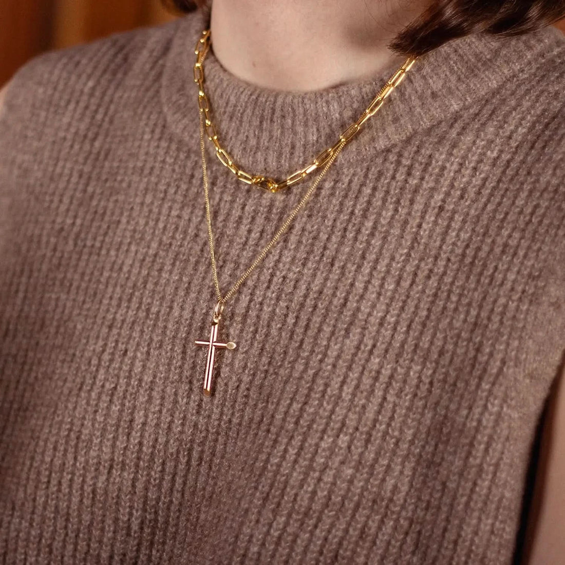 model wearing gold cross necklace with chain