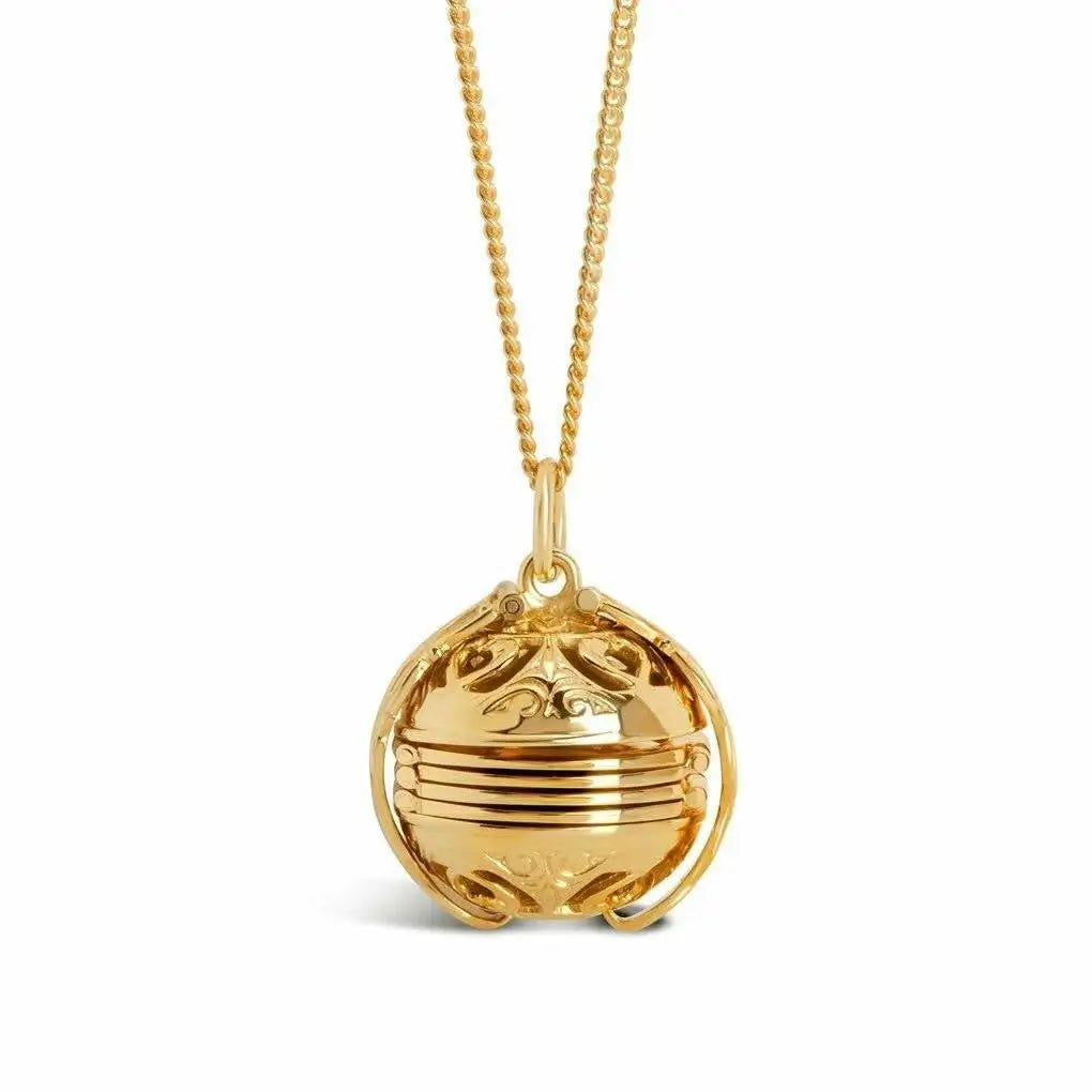 Gold locket necklace with a detailed pendant on a white background