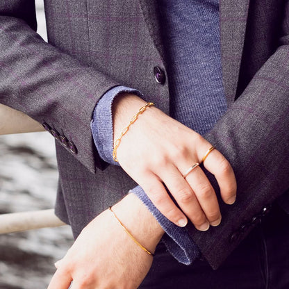 model wearing men's paperclip gold chain bracelet