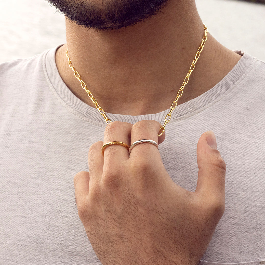 close up of model wearing men's hammered gold ring